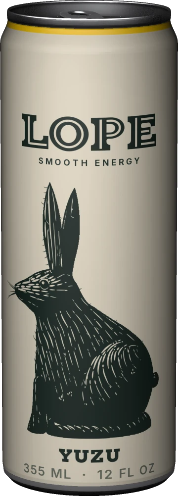 A bone-white can named LOPE standing on the threshold of a dark room under one light; the hare cut as a wood engraving on its label has noticed the lamp: ears up, head lifted